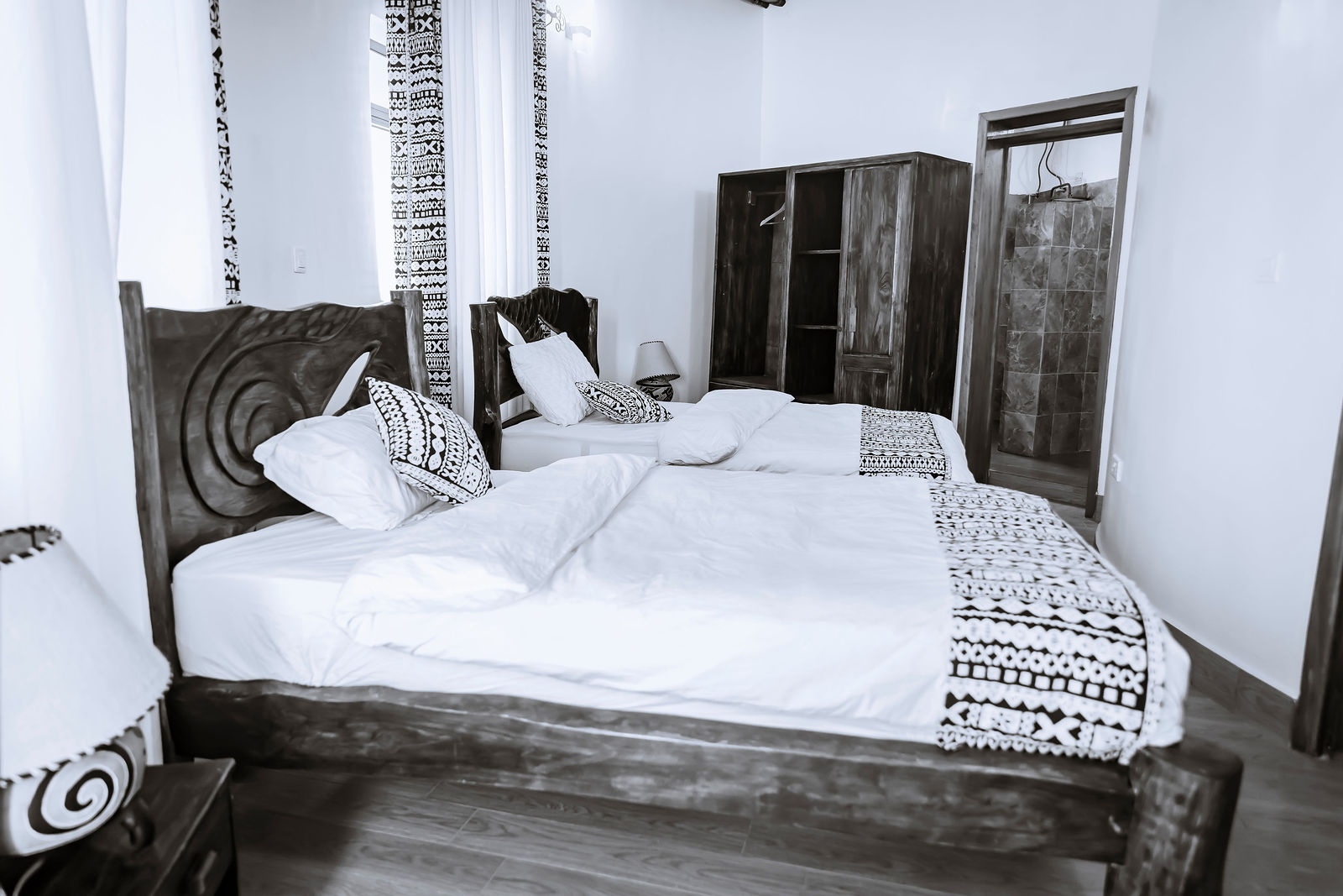 Bright bedroom with carved headboard and wardrobe