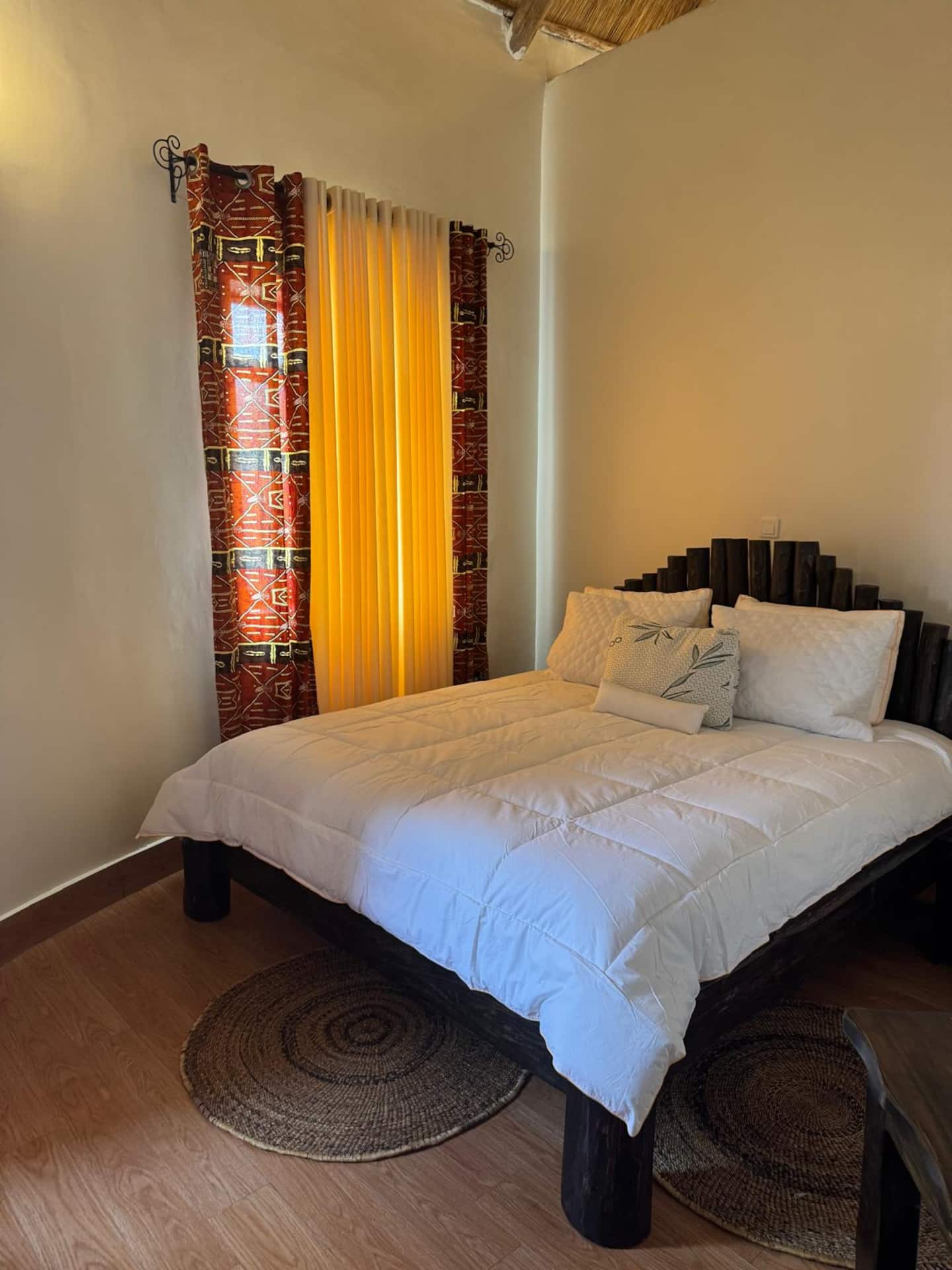 King bedroom with carved wooden headboard