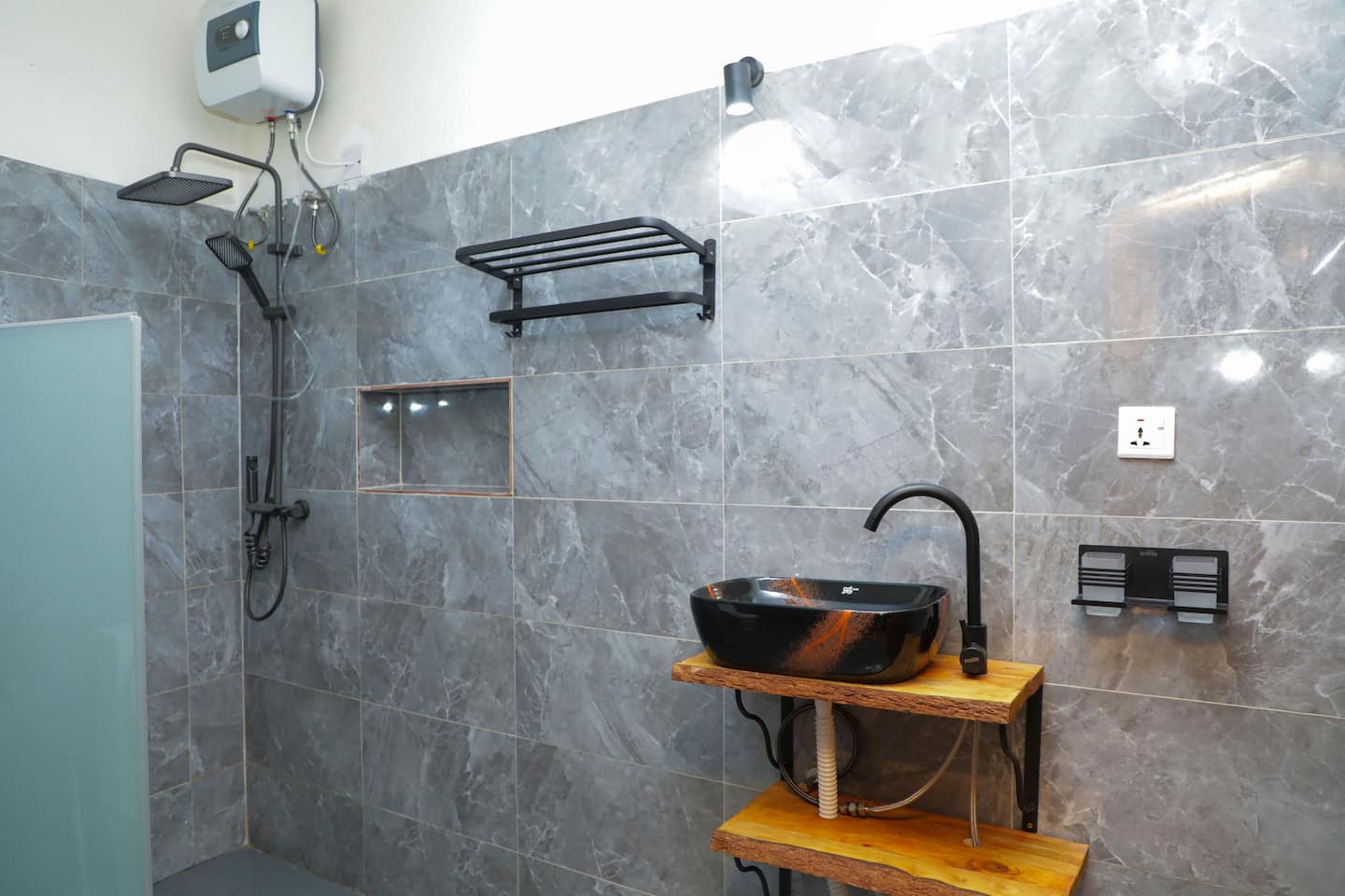 Walk-in rain shower with stone tiling