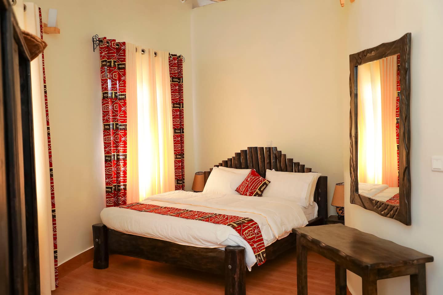 Double bedroom with warm lamplight and hardwood floors