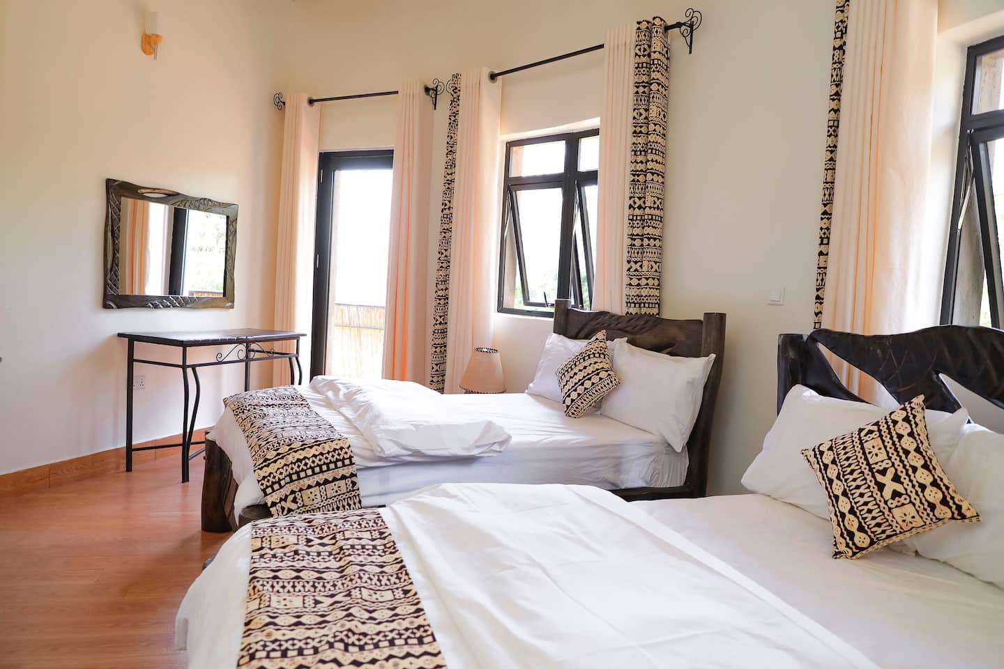 Twin bedroom with Imigongo-patterned textiles