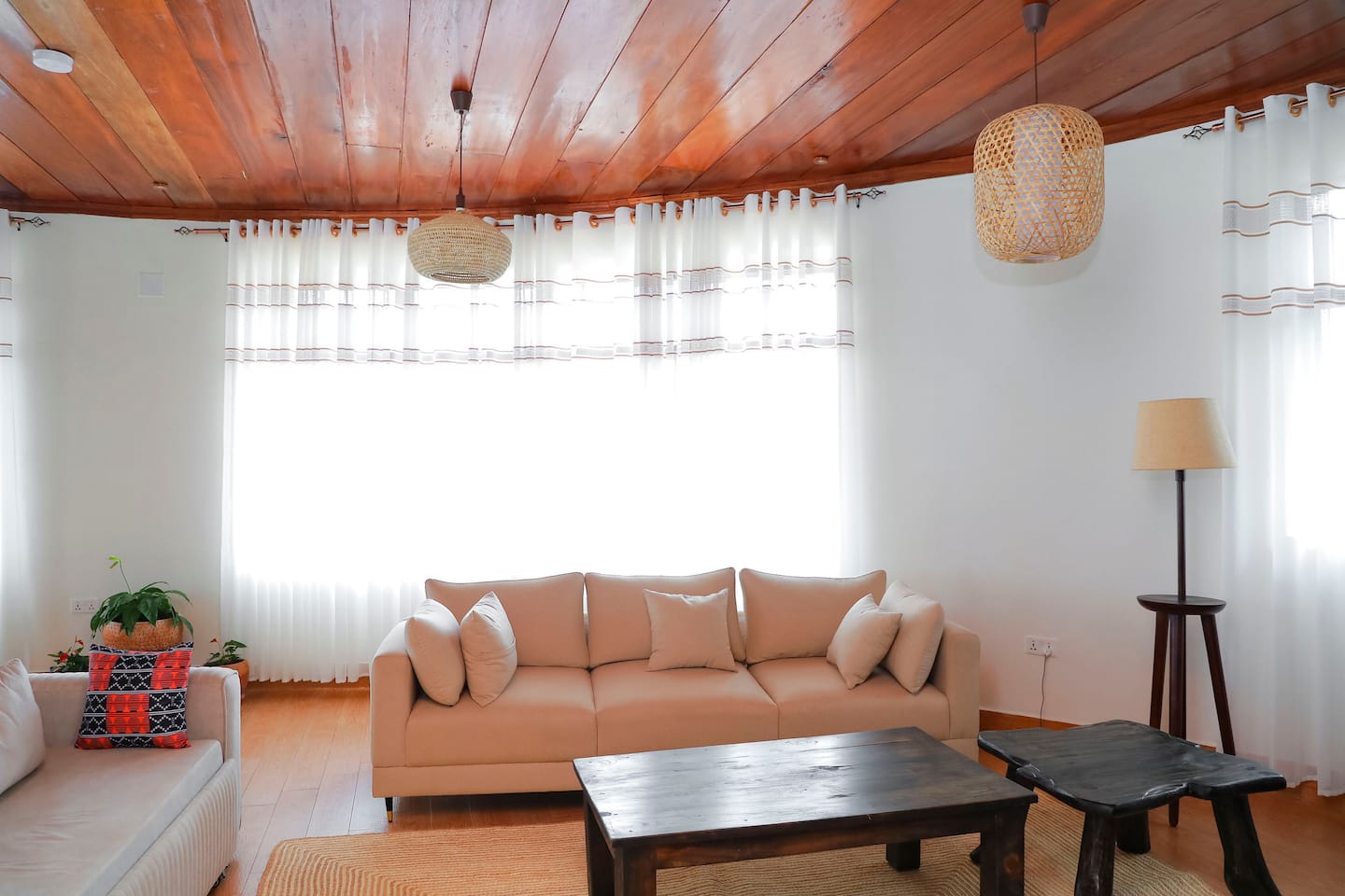 Lounge with woven pendant lights and handcrafted wooden table