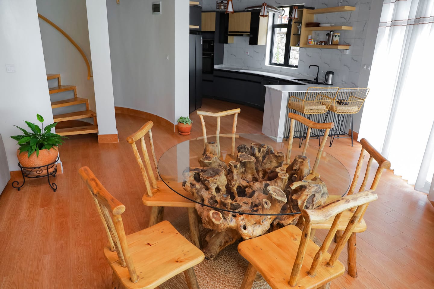 Open kitchen and dining table with root-wood base