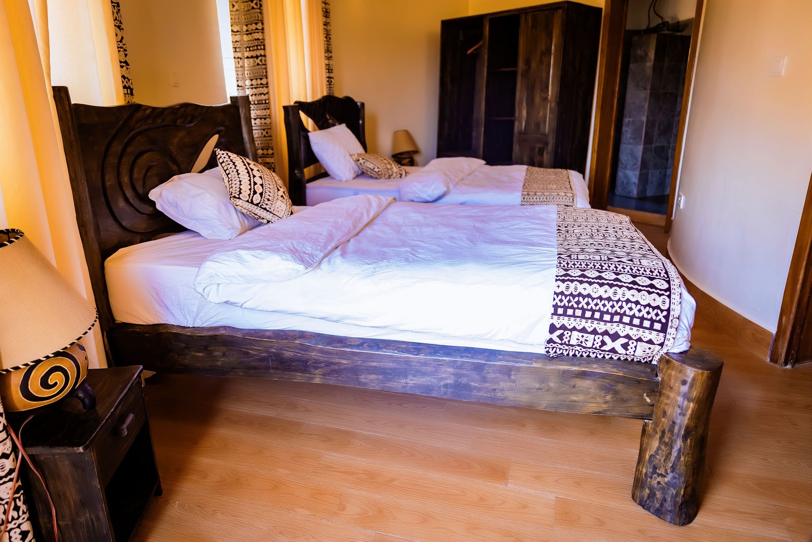 Double bedroom with carved bed frame and warm light