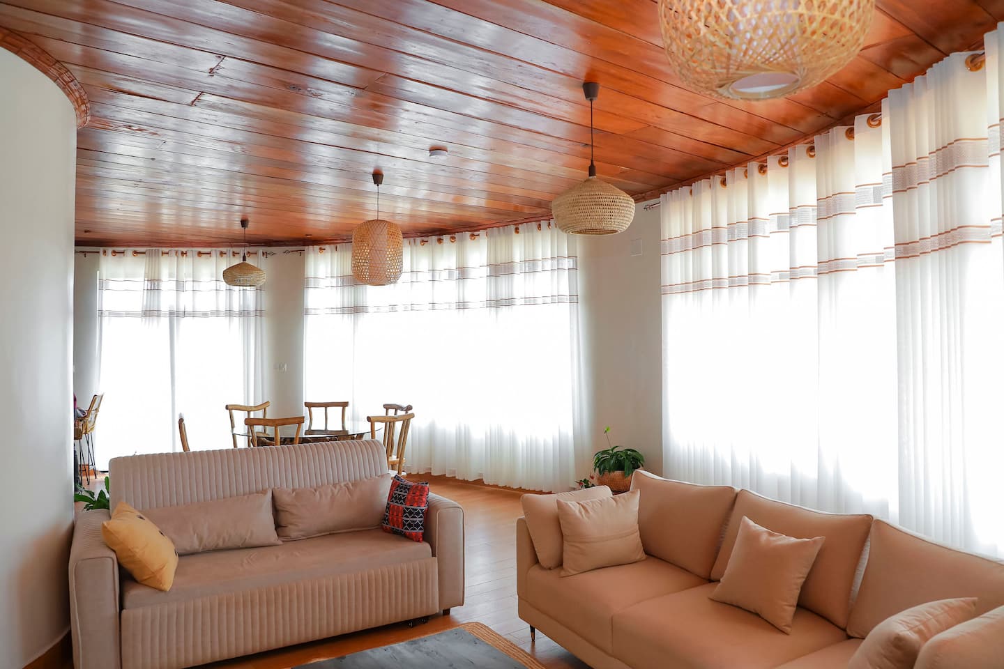 Bright curved living room with sofas and lake-facing windows